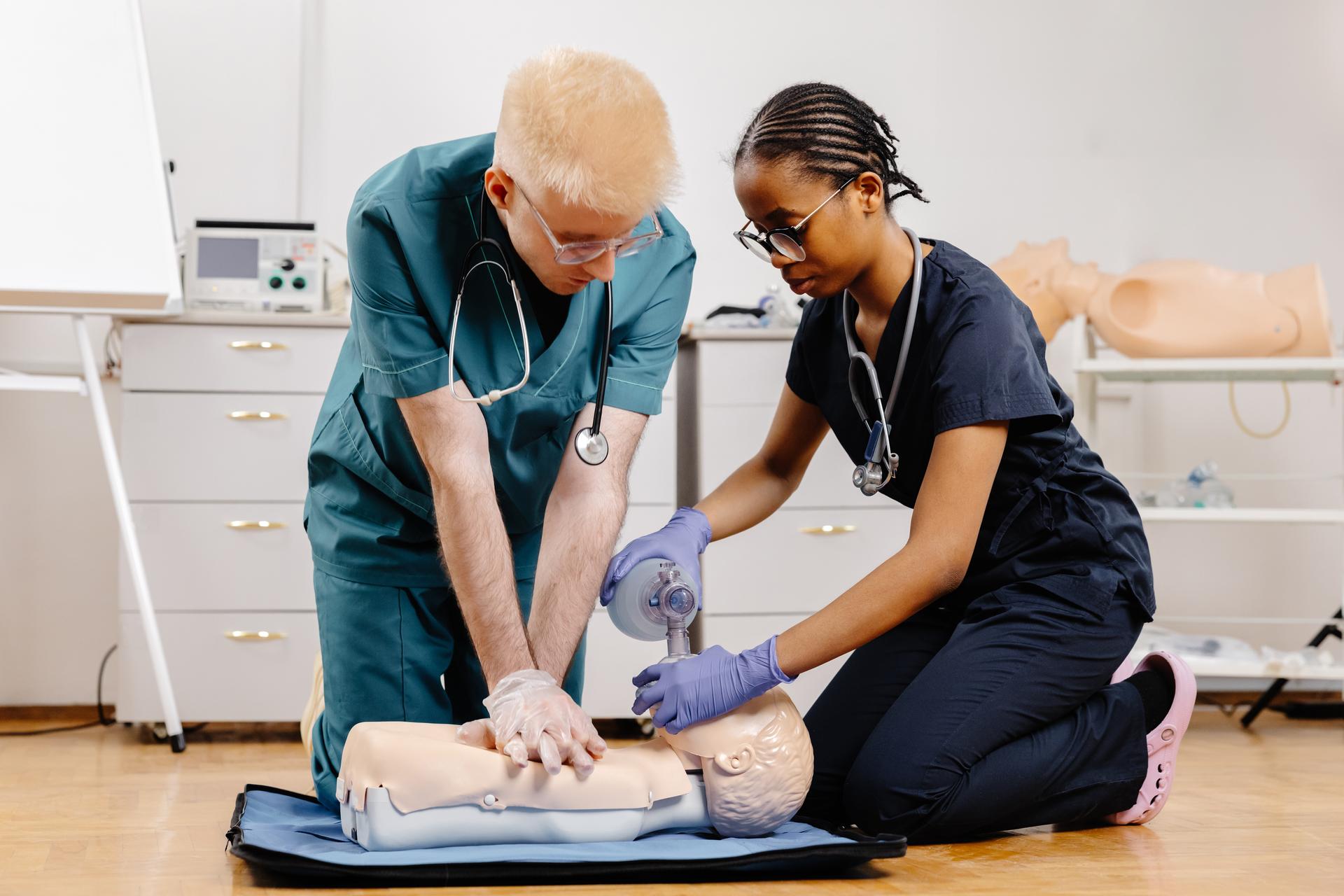 Medical Professionals Performing CPR Training on Mannequin