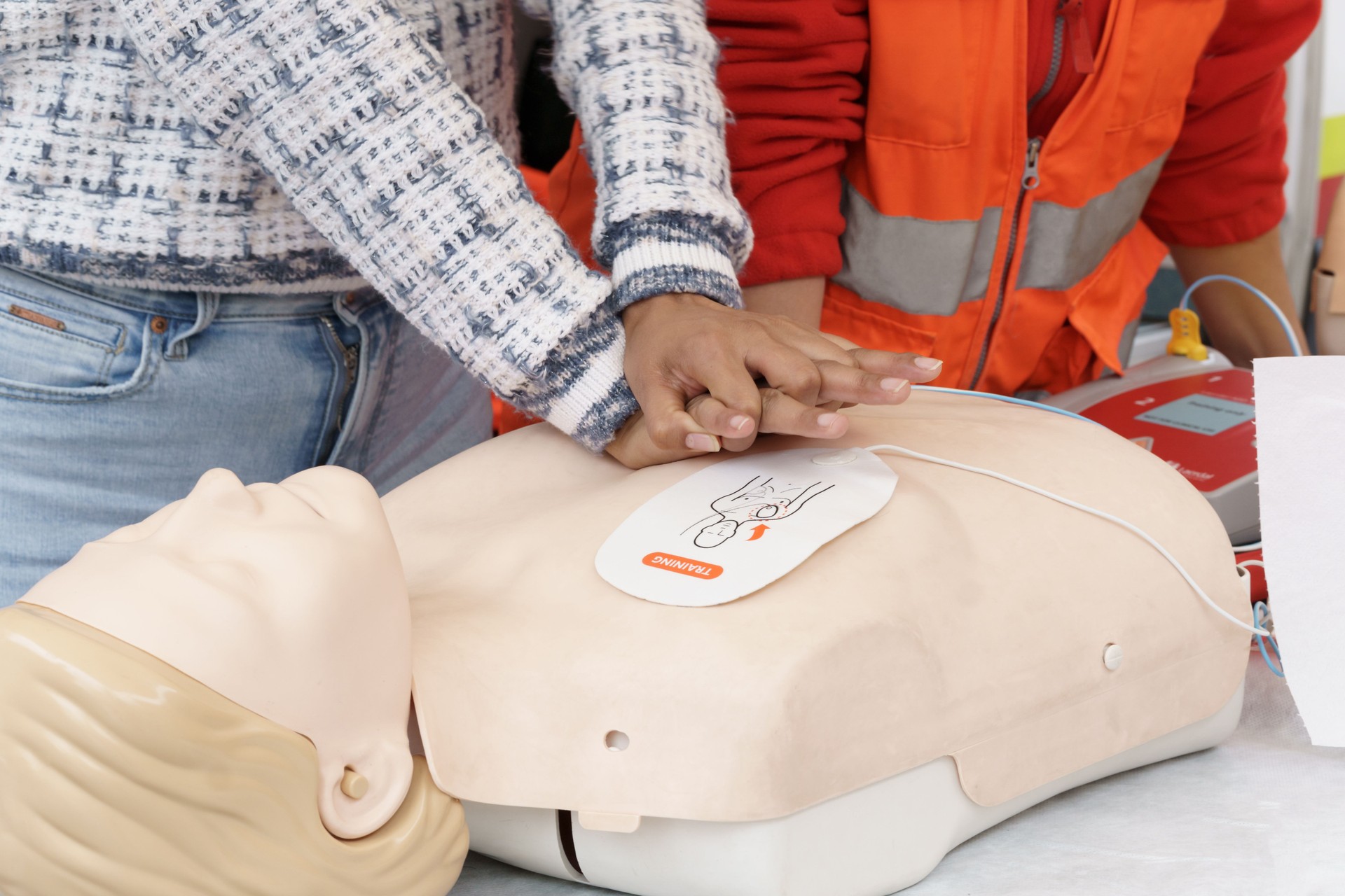 CPR training with mannequin and AED by instructor