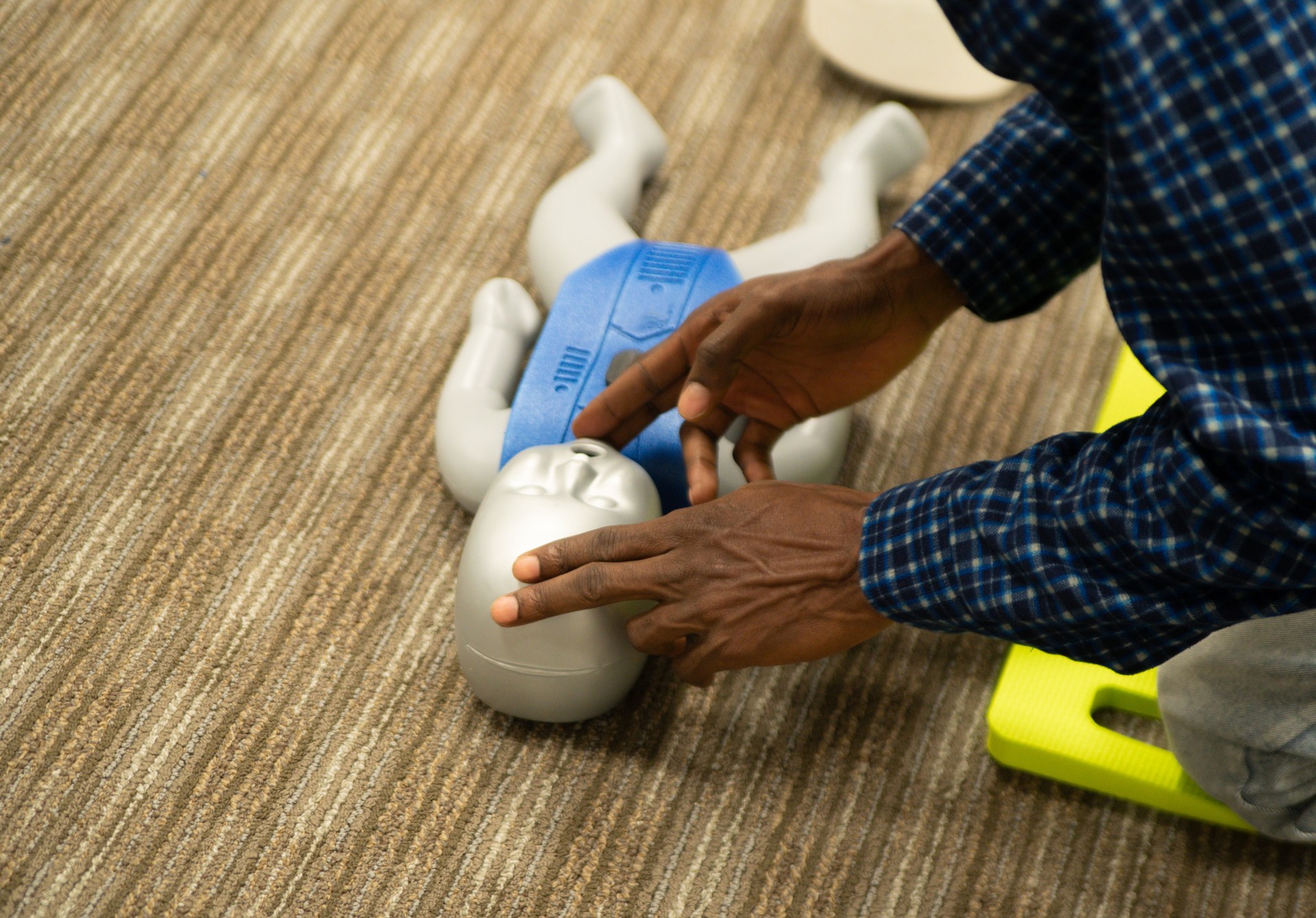Emergency and Standard First aid and CPR training class by security guard in office